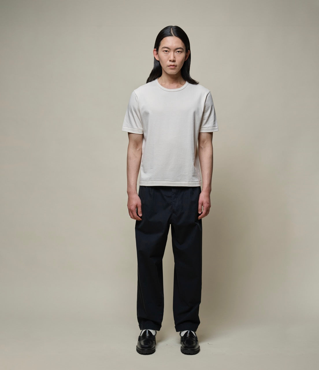 Man wearing a cropped nature T-shirt and black pants