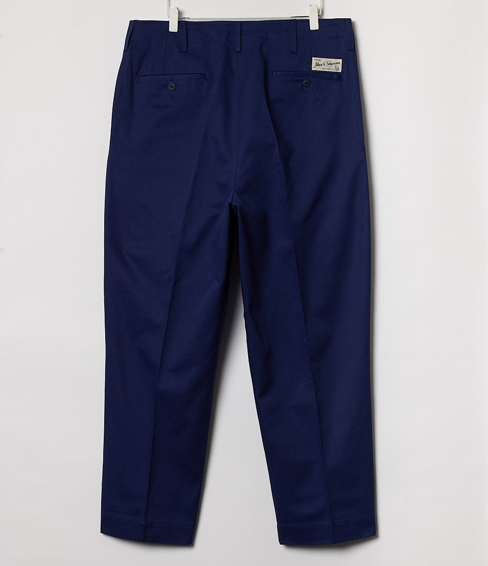 Navy blue pants hanging against a white background