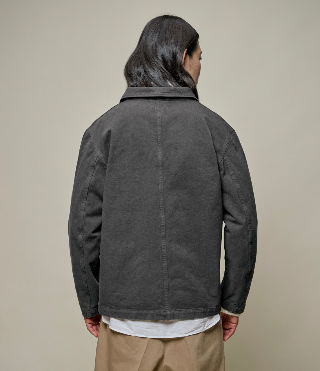 Backside of person wearing a dark grey jacket