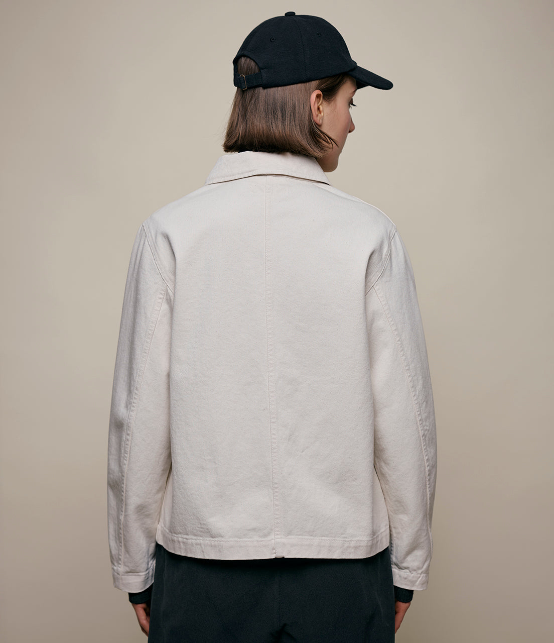 Person wearing beige cotton twill jacket