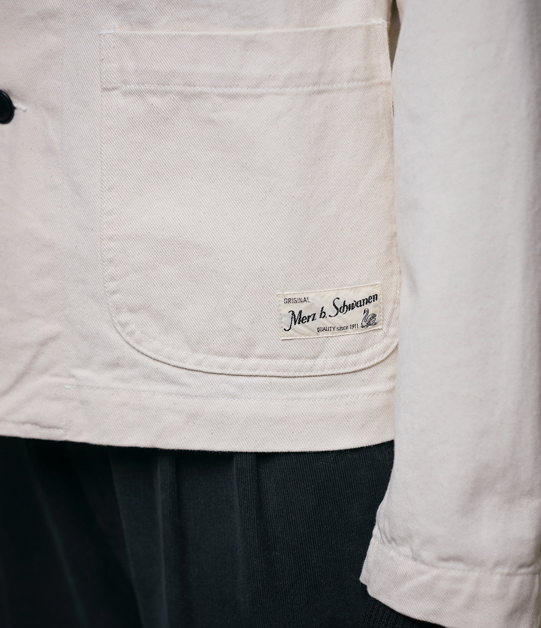 Close up shot of beige cotton twill jacket and logo