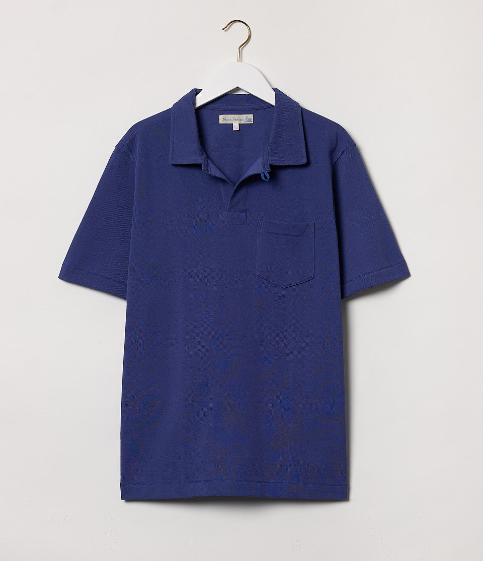 Blue loopwheeled polo shirt on a hanger against a white background