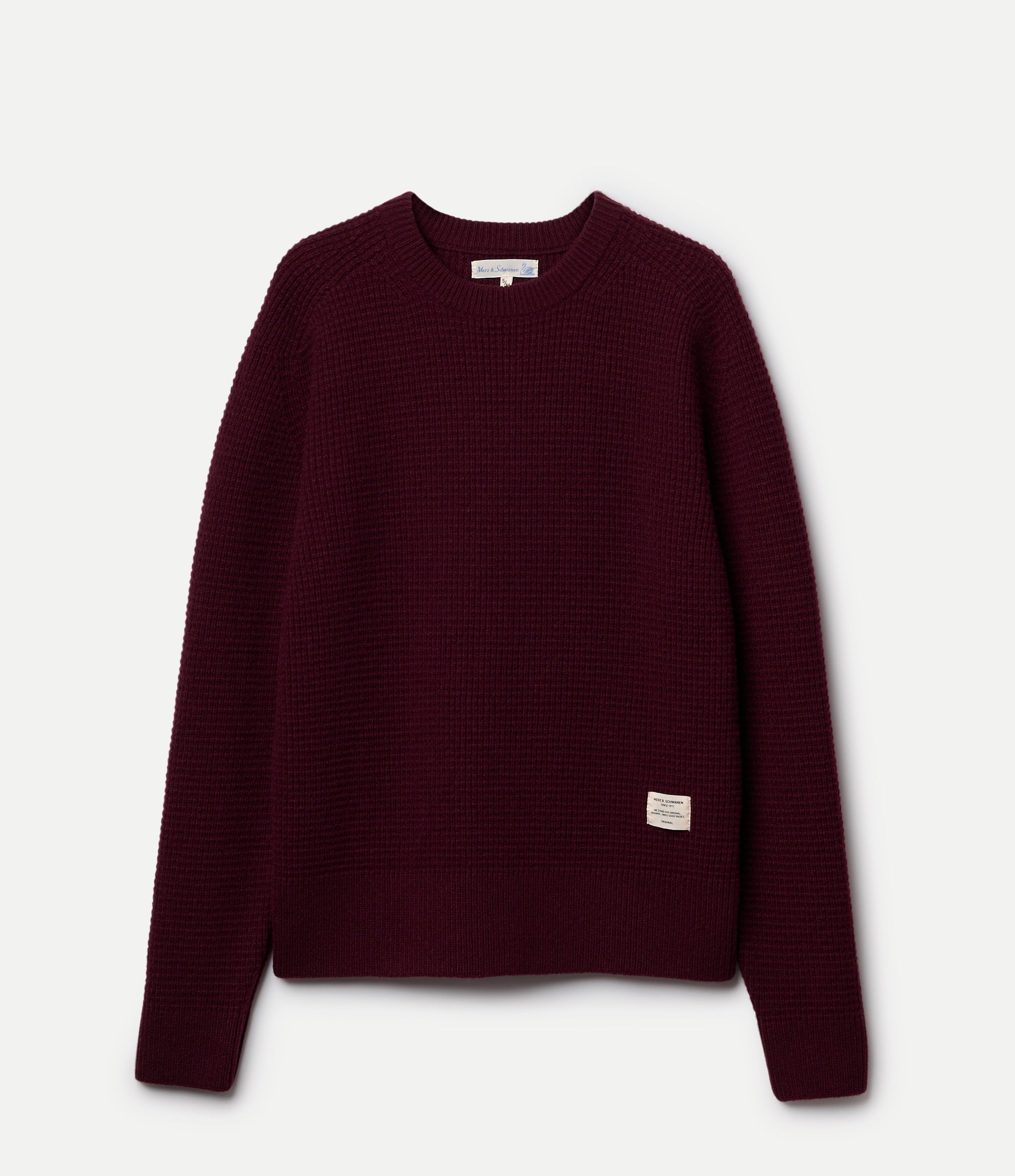 Maroon sweater on a light gray background