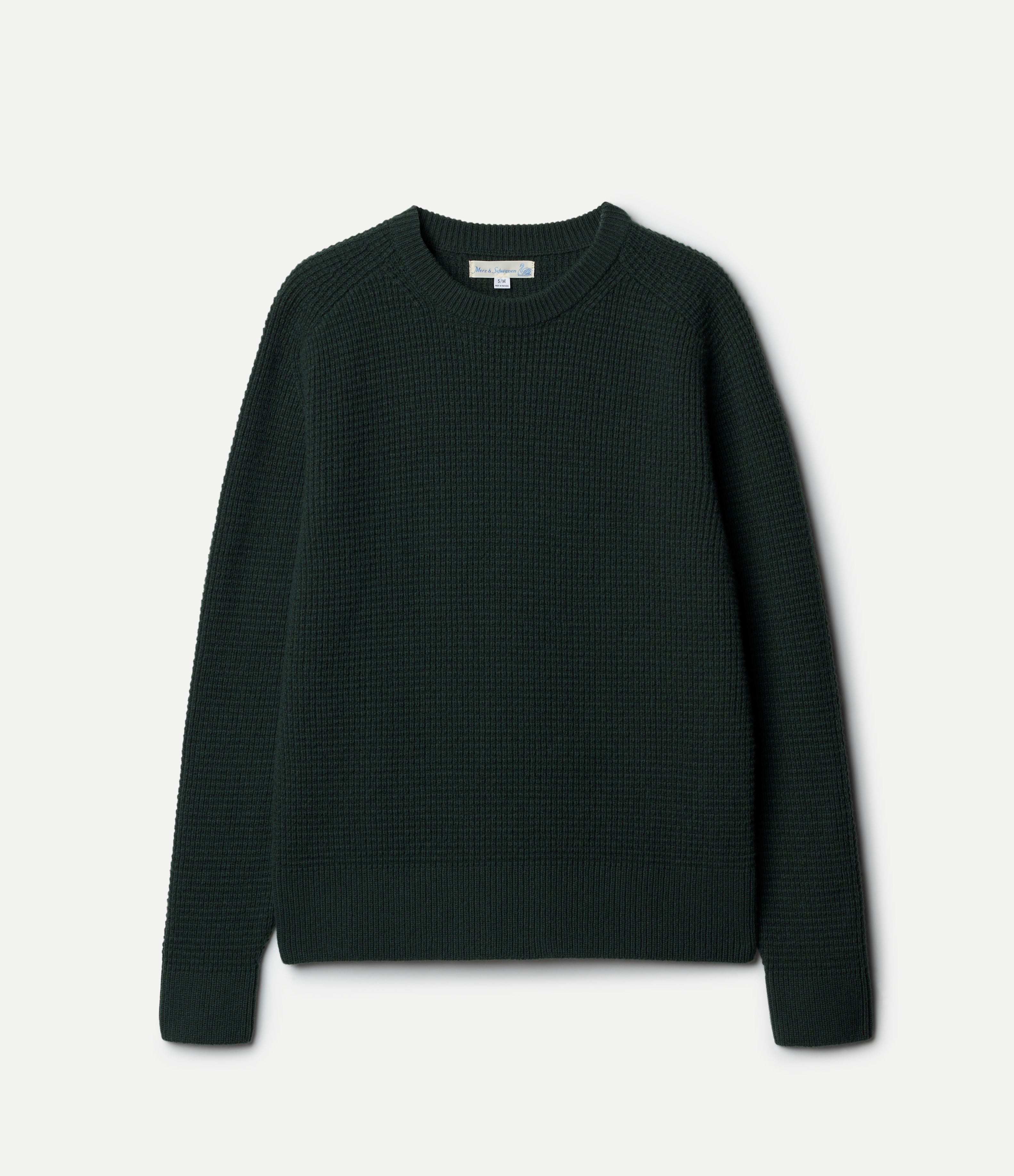 Green textured sweater on a light gray background