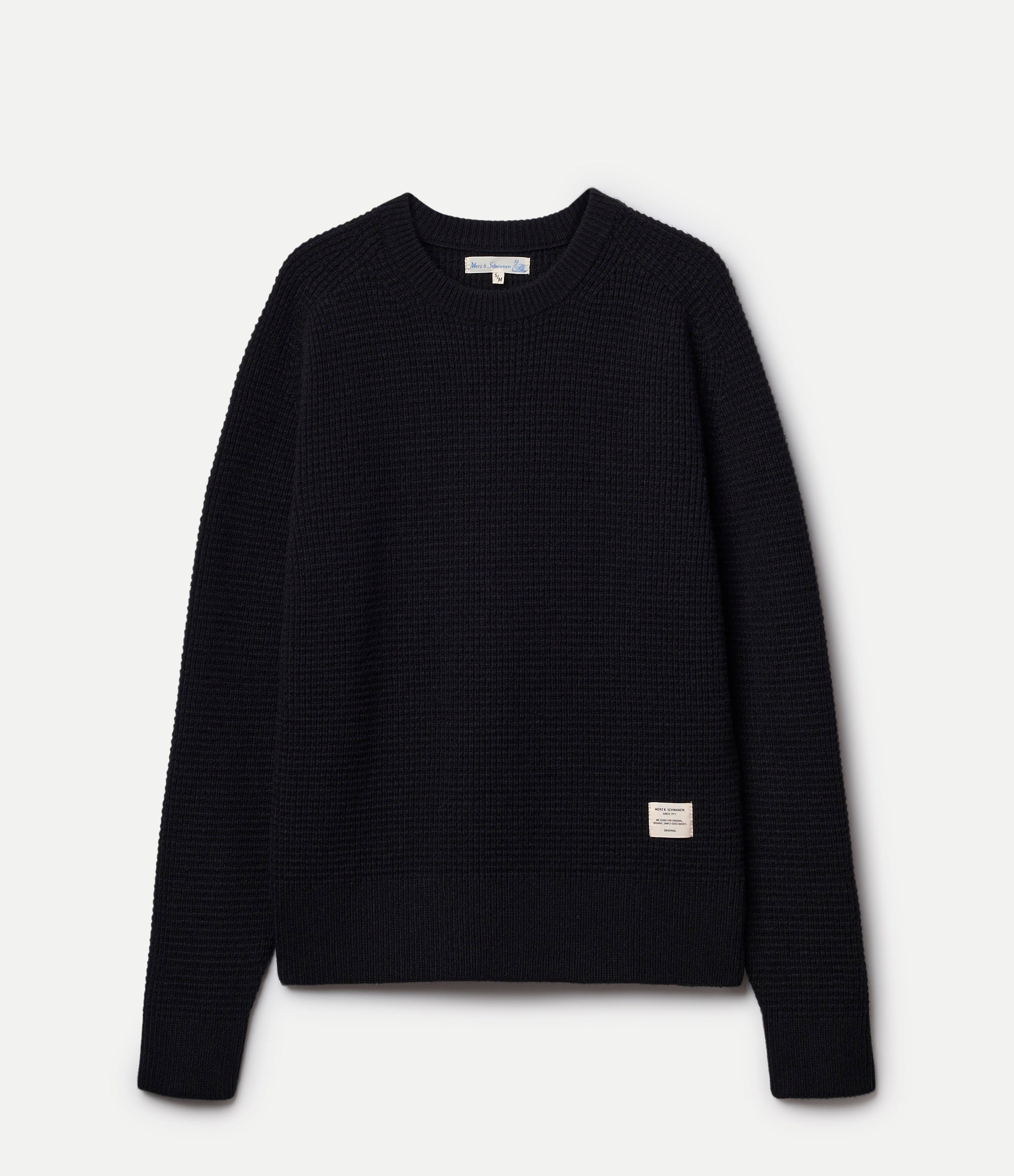 Black textured sweater on a light gray background