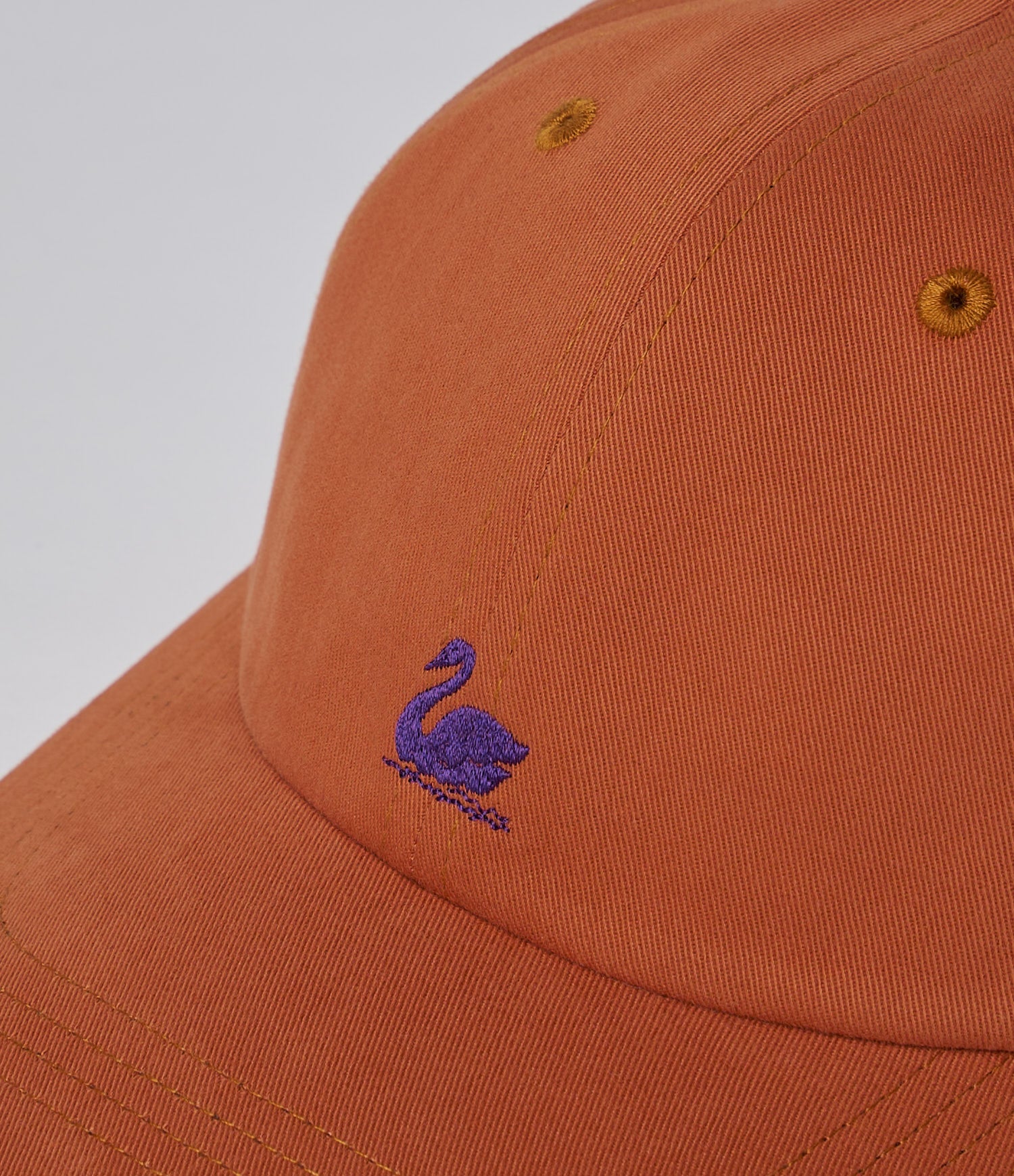 Orange cap with a blue swan logo on a light gray background