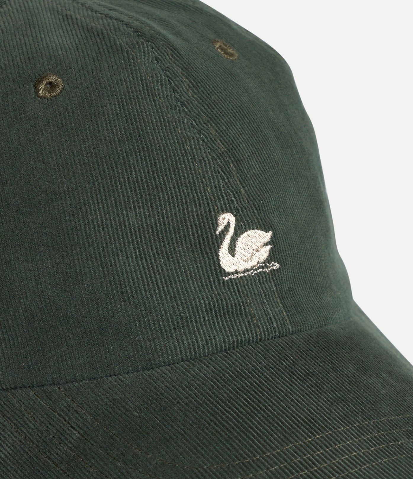 Dark green cap with a white embroidered swan design on a light gray background