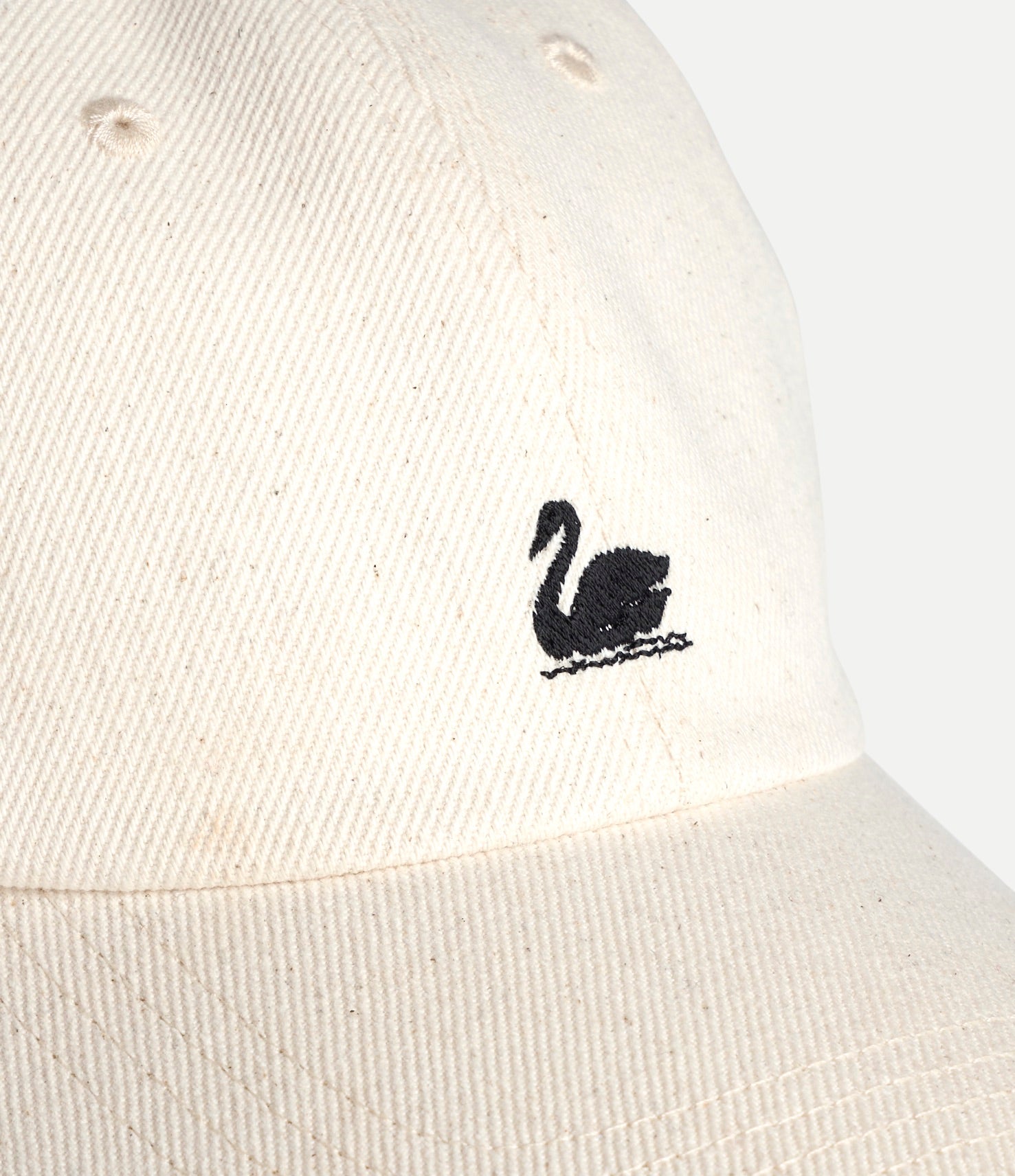 White cap with a black swan logo on a white background