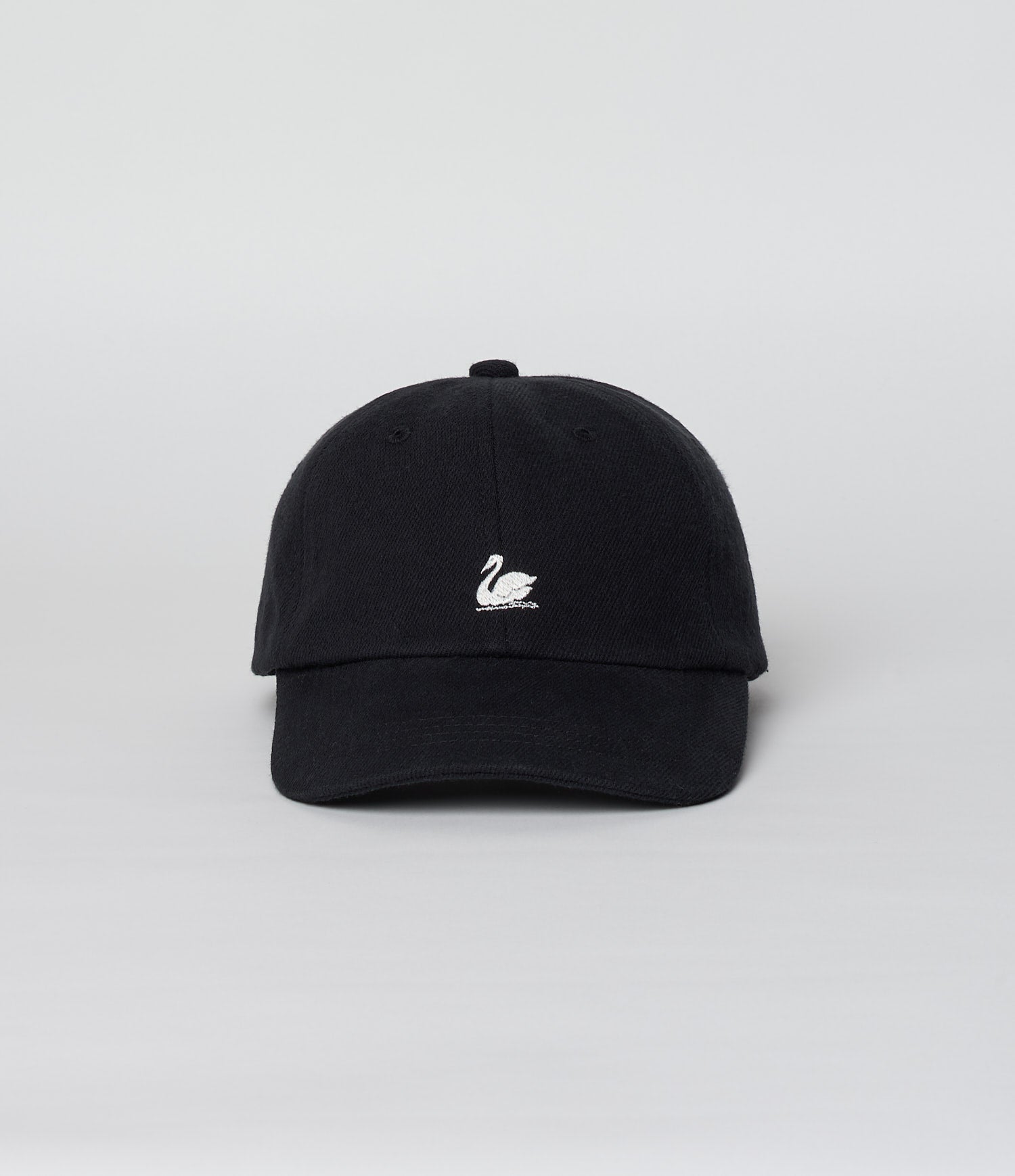Black cap with a white logo on a light gray background