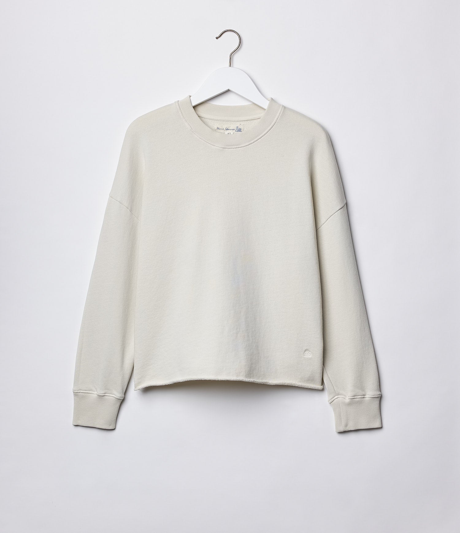 Beige sweatshirt on a hanger against a white background