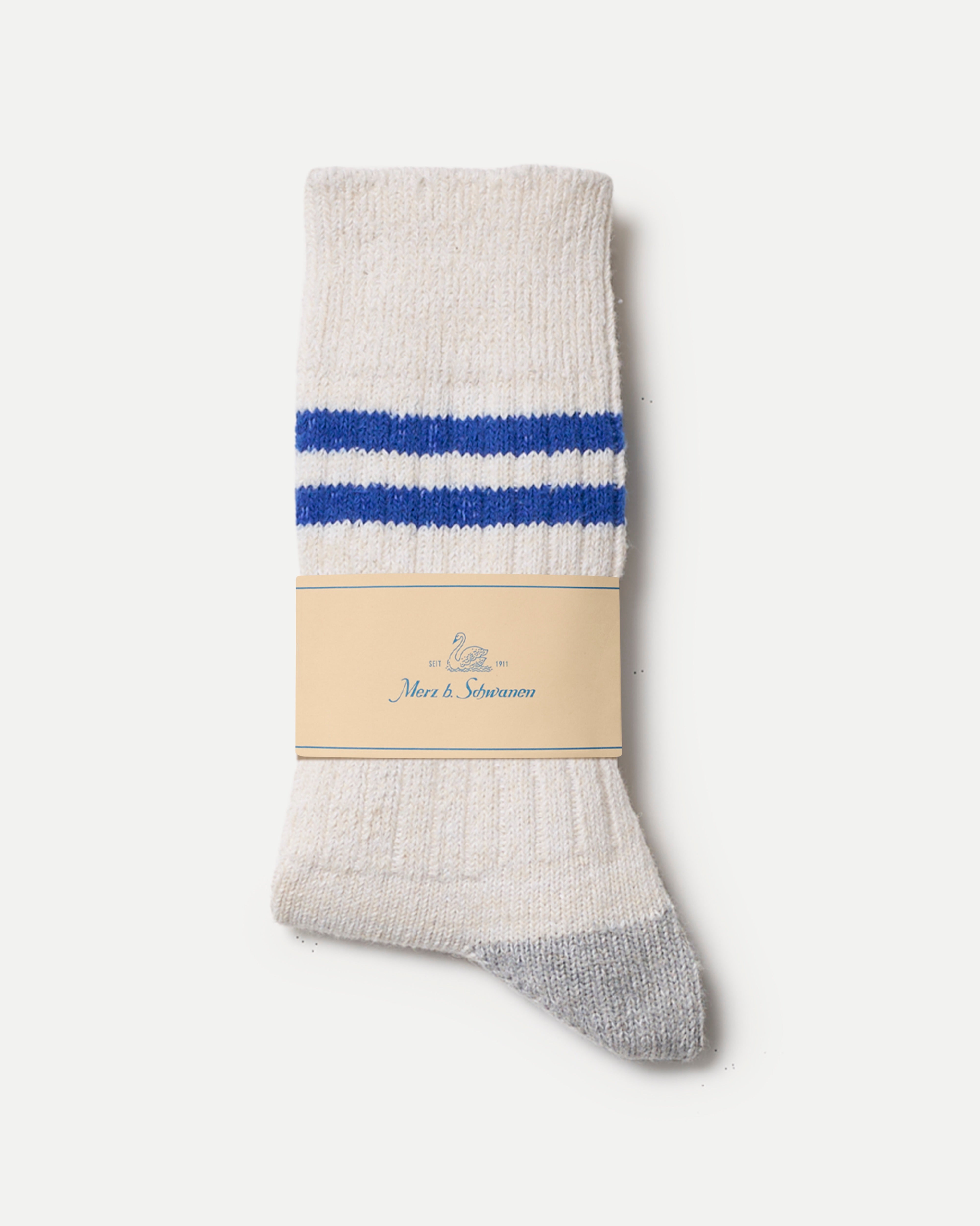 White sock with blue stripes and a visible Merz b. Schwanen label on a white background