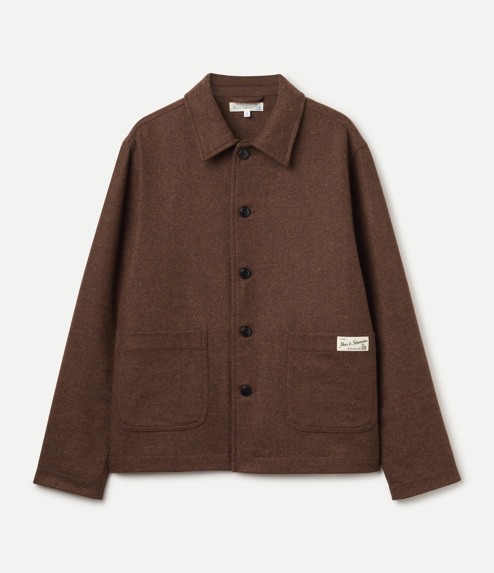 A brown wool tweed utility jacket with a pointed collar, dark buttons, and two front patch pockets, shown flat against a light off-white background.