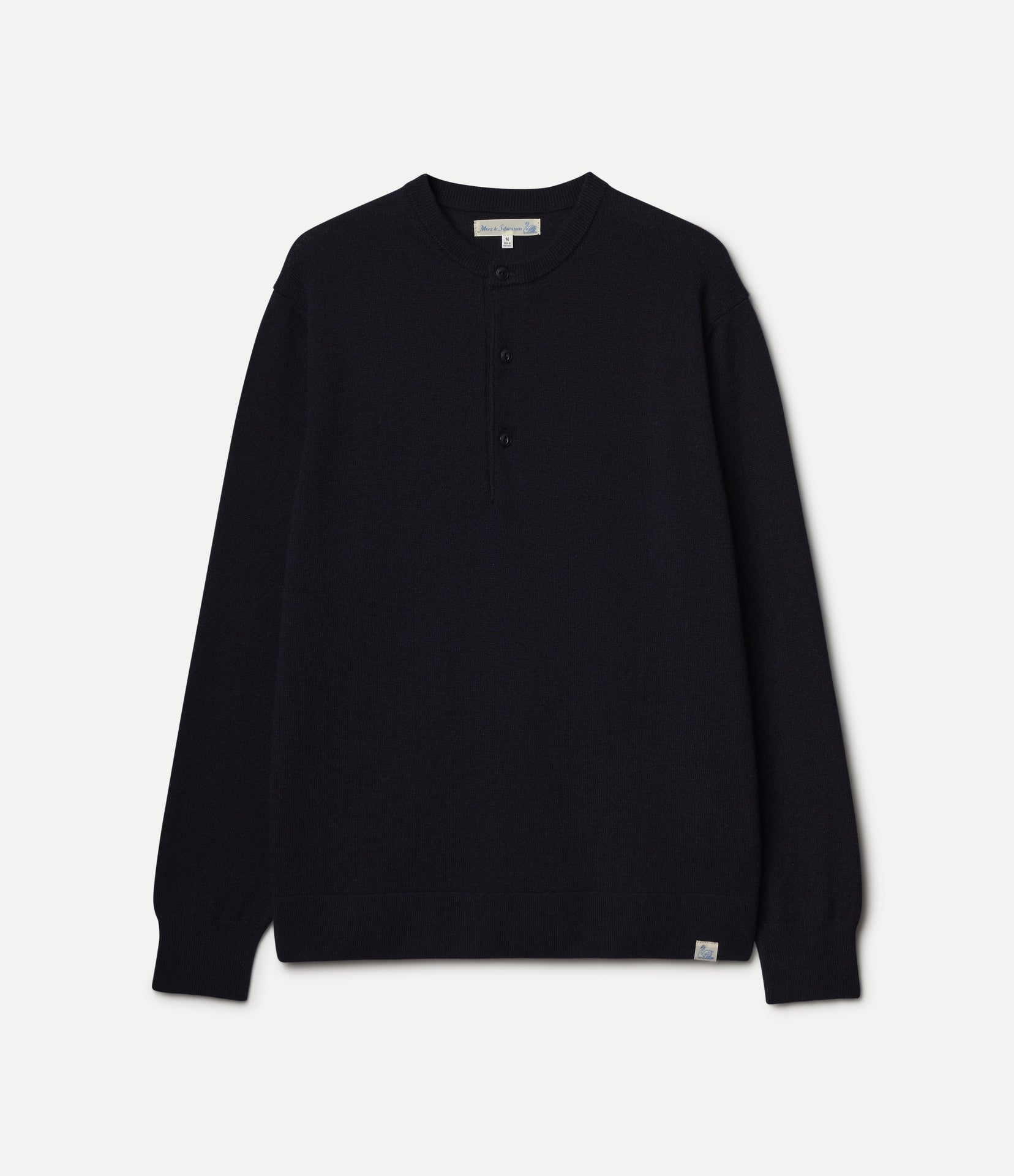 A dark navy long-sleeve henley sweater with a three-button placket, displayed flat against a light off-white background.