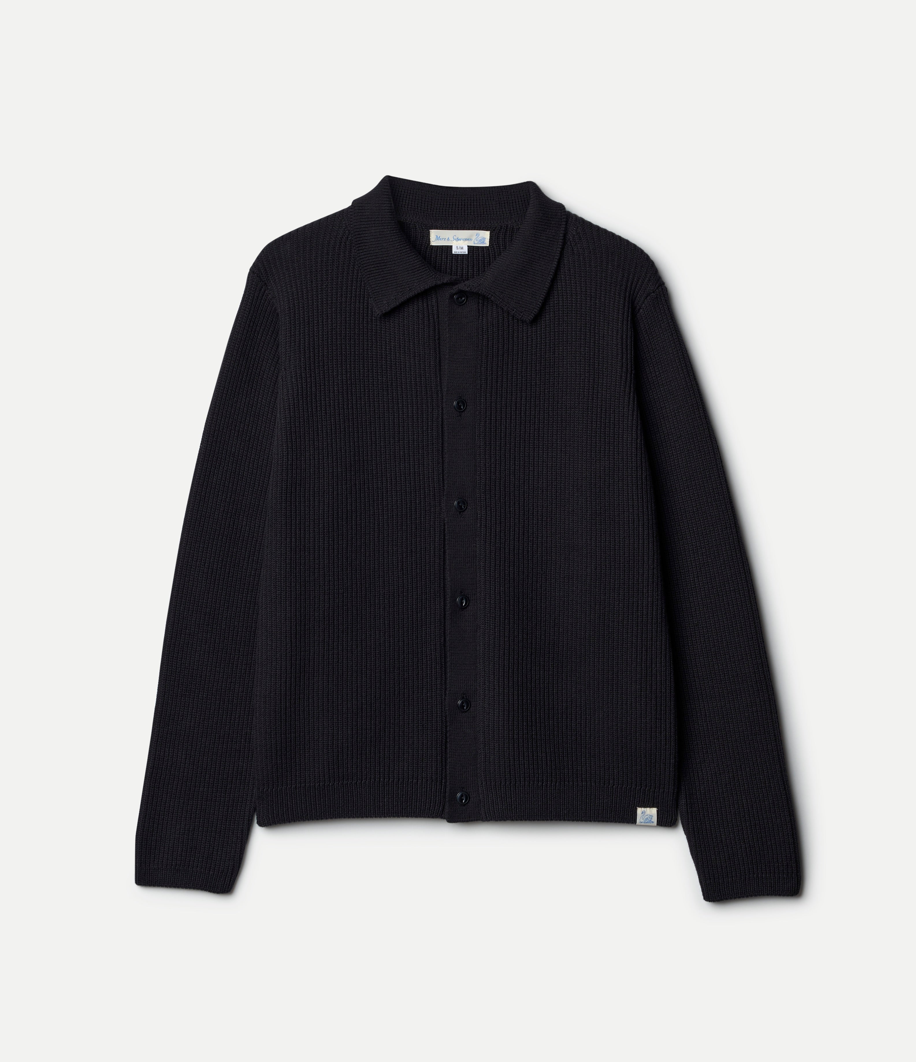 Black ribbed knit shirt on a light gray background