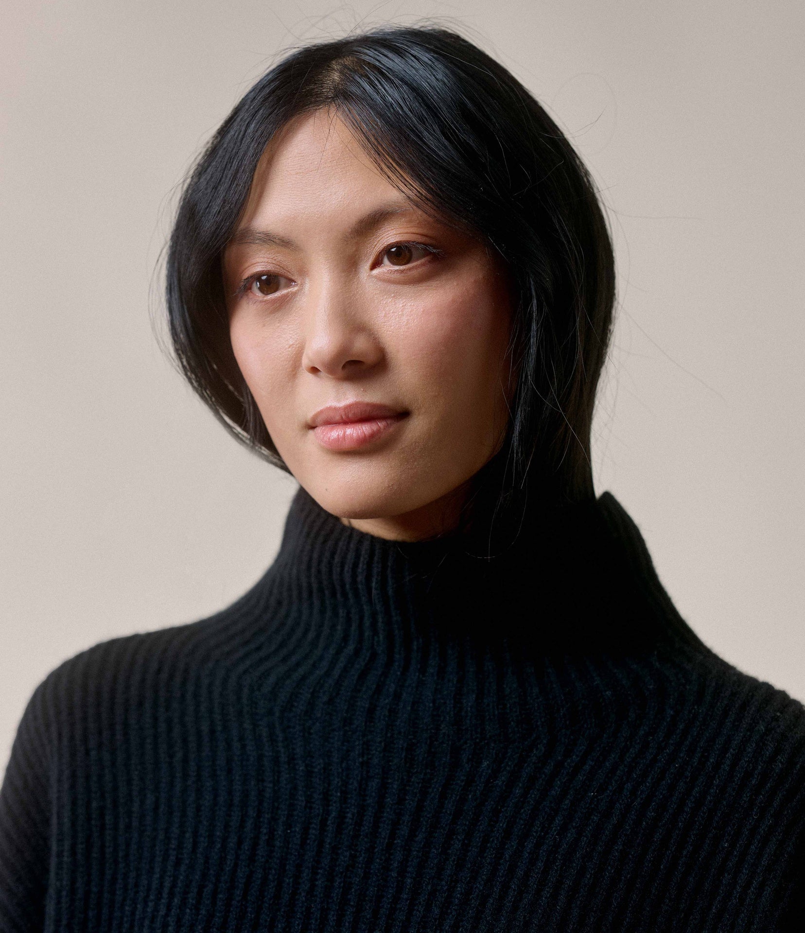 Person wearing a black turtleneck sweater