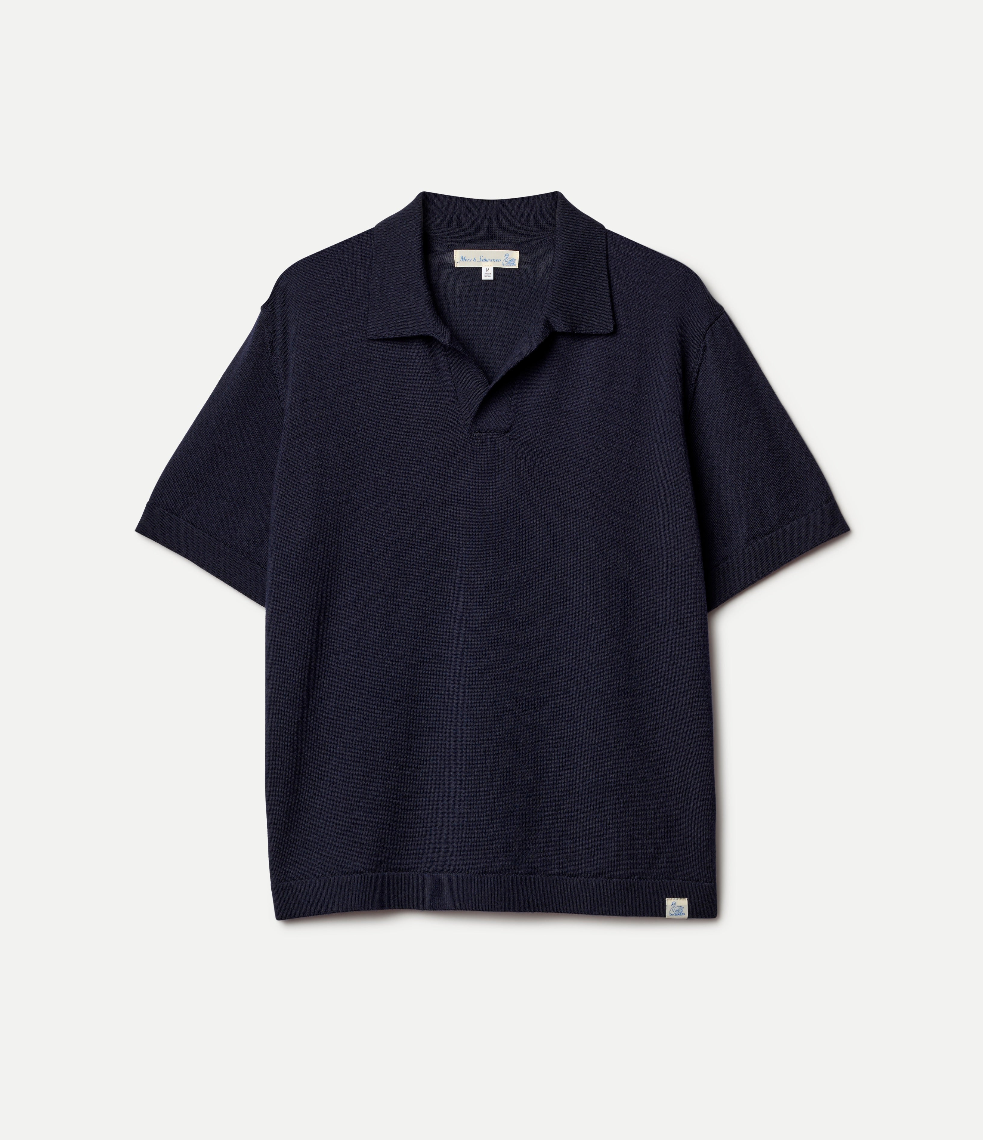 Navy knitted merino wool polo shirt on a light gray background