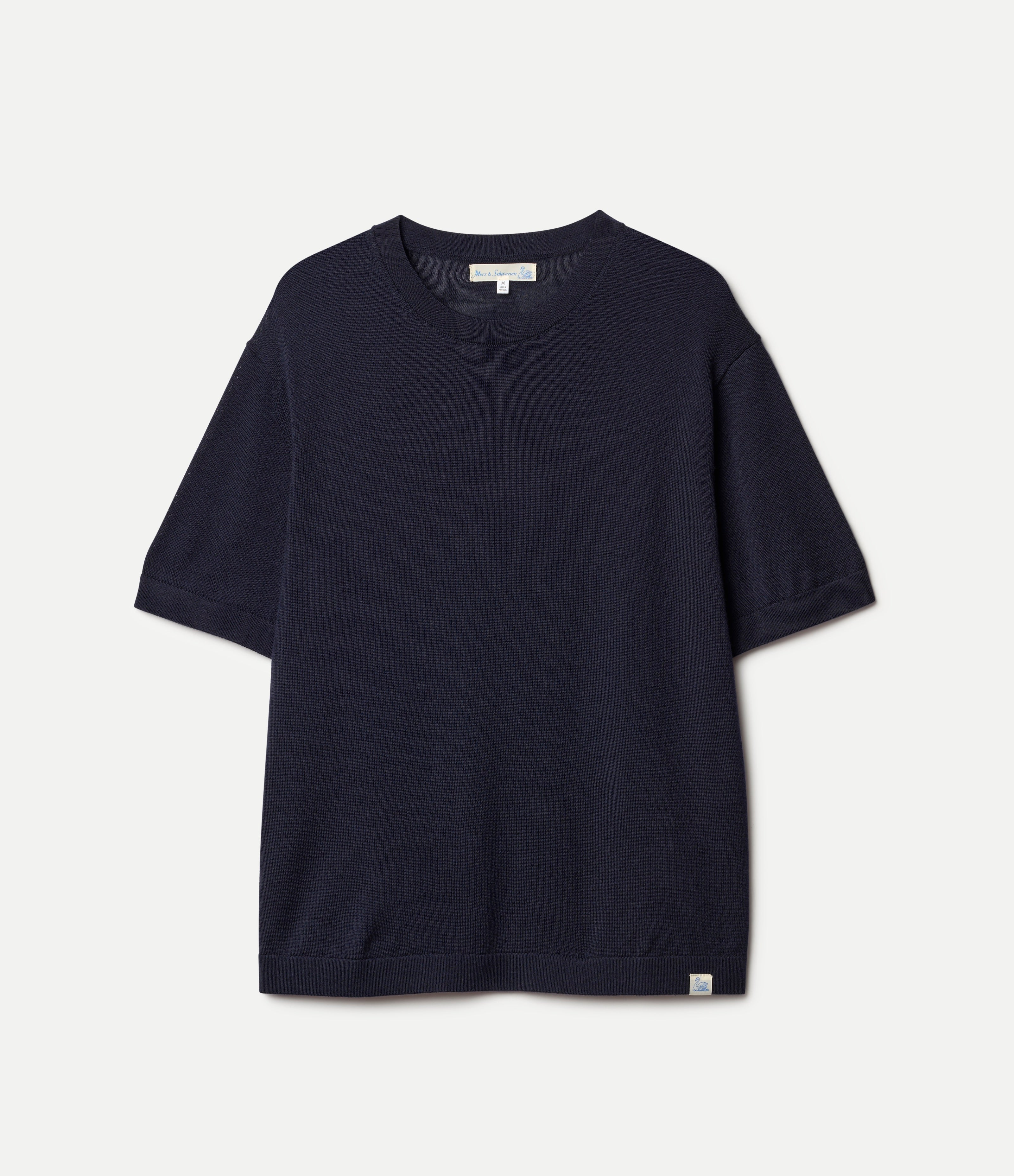 Navy blue knitted merino wool t-shirt on a light gray background