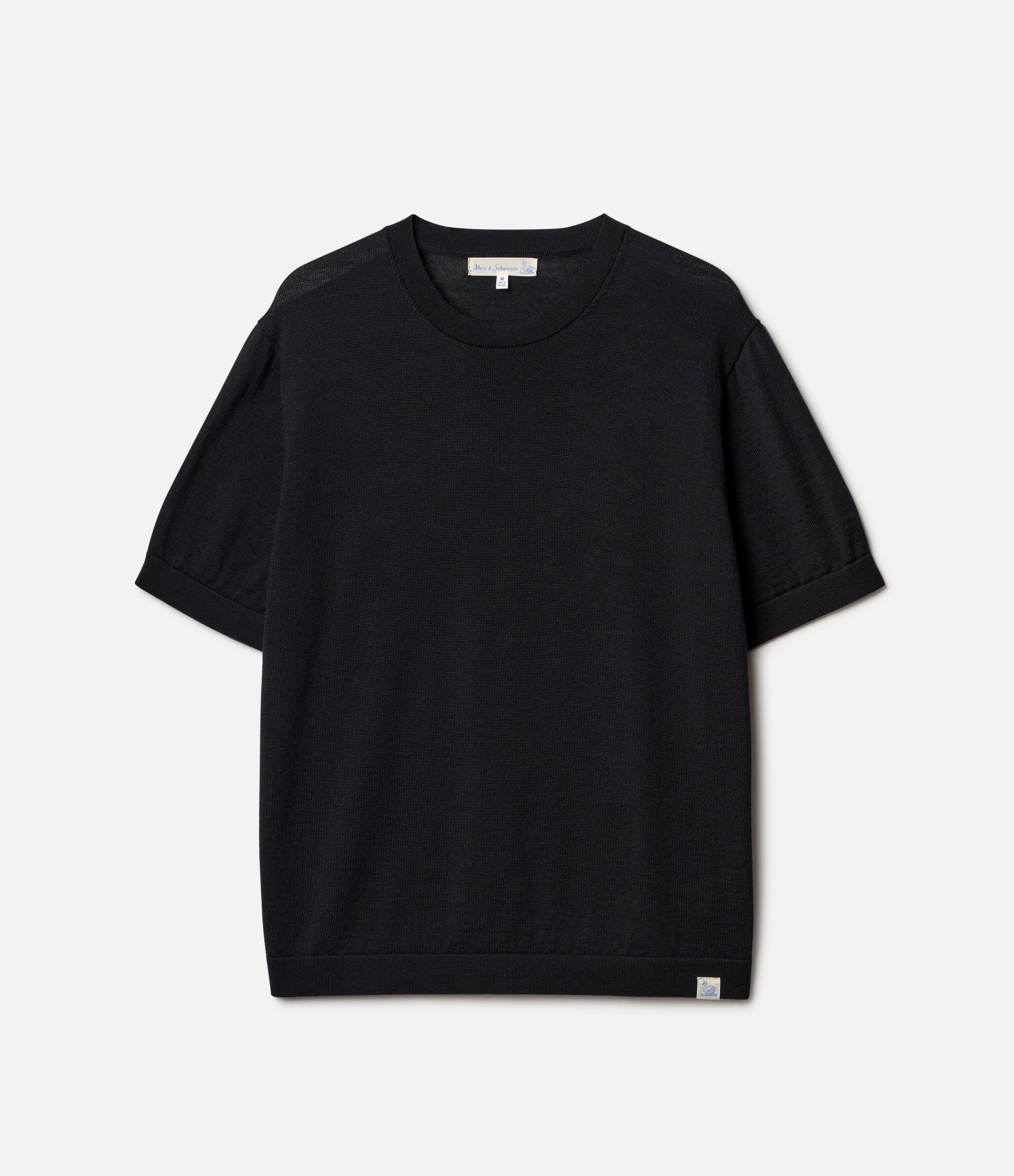 Black knitted merino wool t-shirt on a light gray background