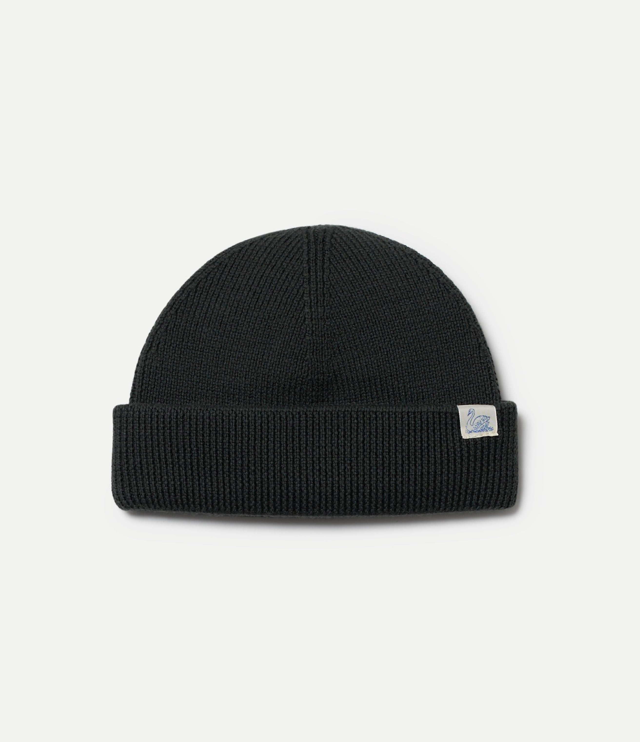 Army green merino wool beanie with a Swan brand label on a light gray background