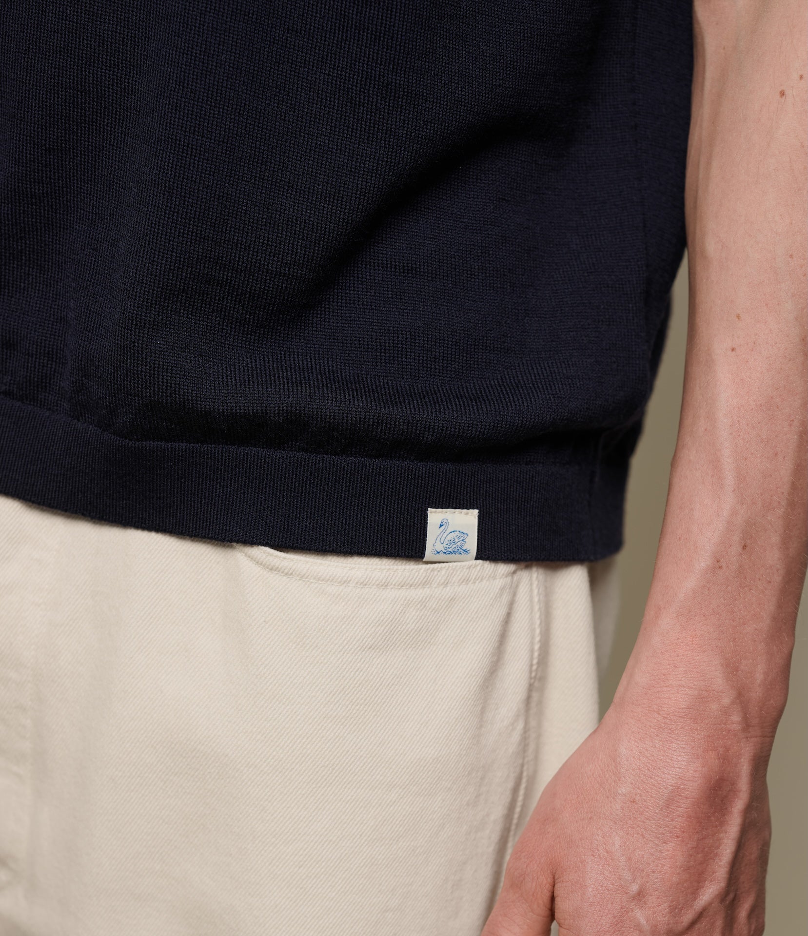 Navy merino wool T-shirt with a brand logo on a neutral background