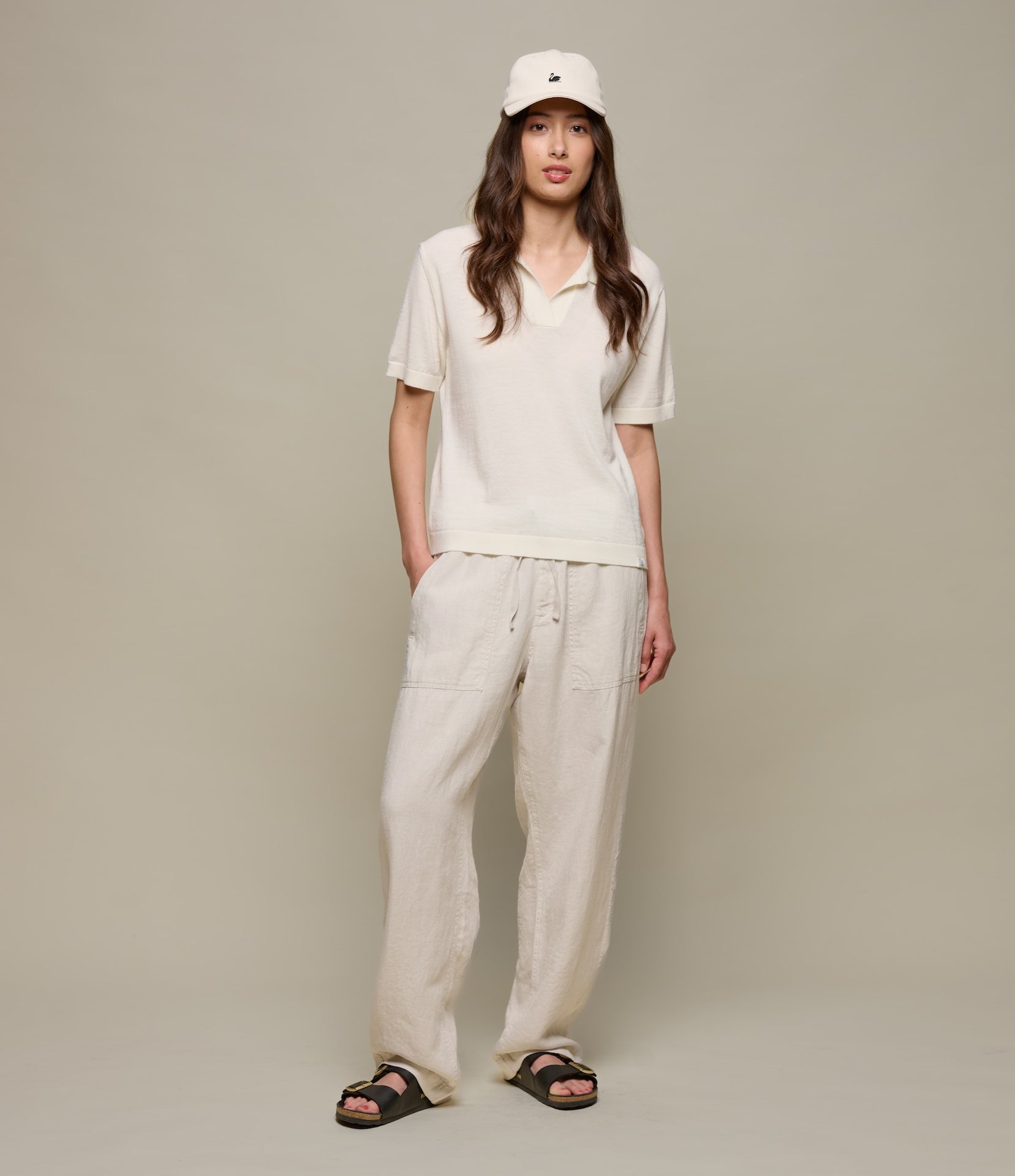 Woman wearing a beide outfit with a beige background