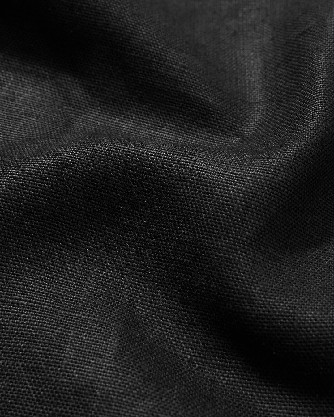 Close-up of black linen fabric with a textured pattern