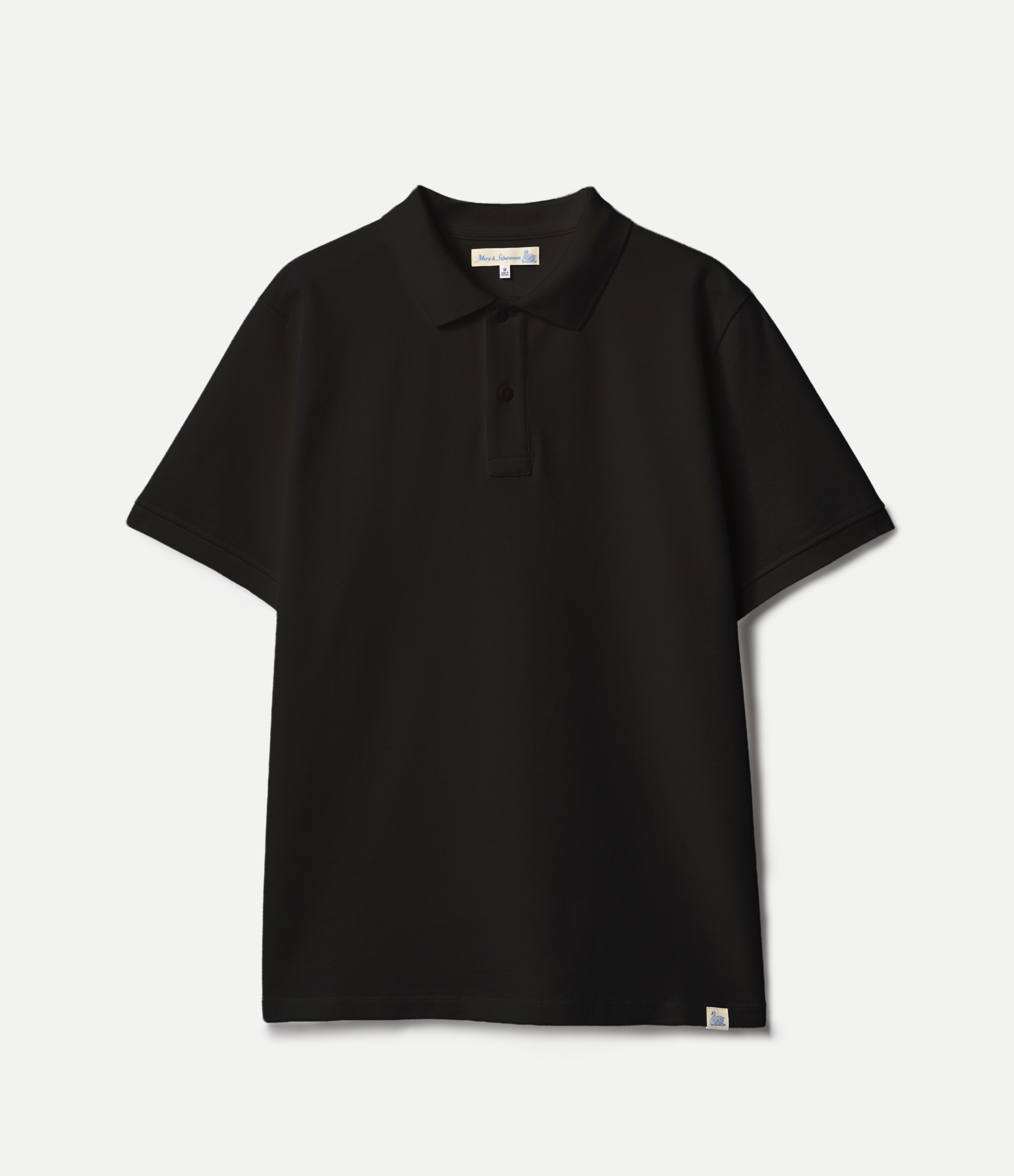 Black pikée polo shirt on a light gray background