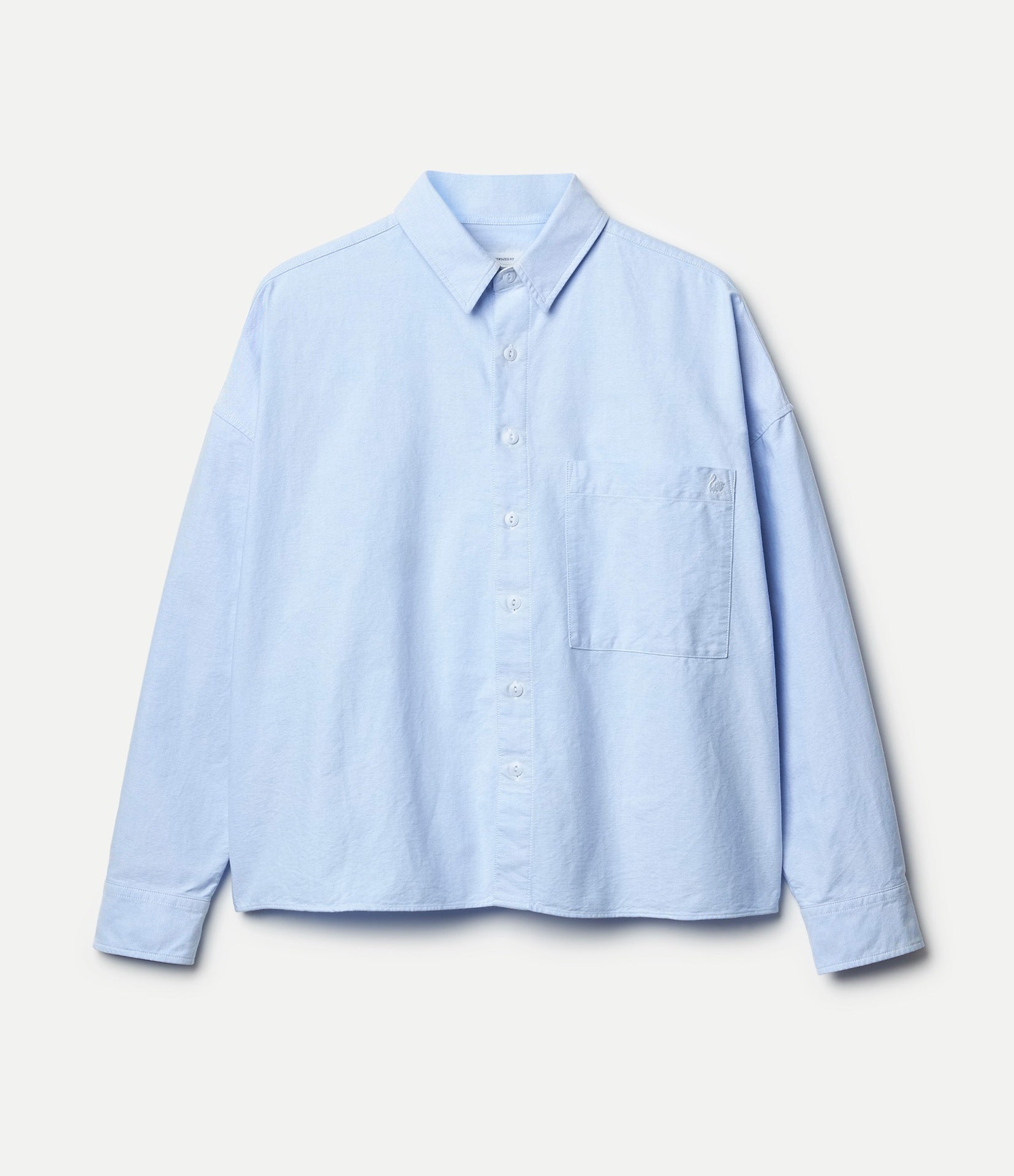 Cropped oxford shirt in blue on a white background