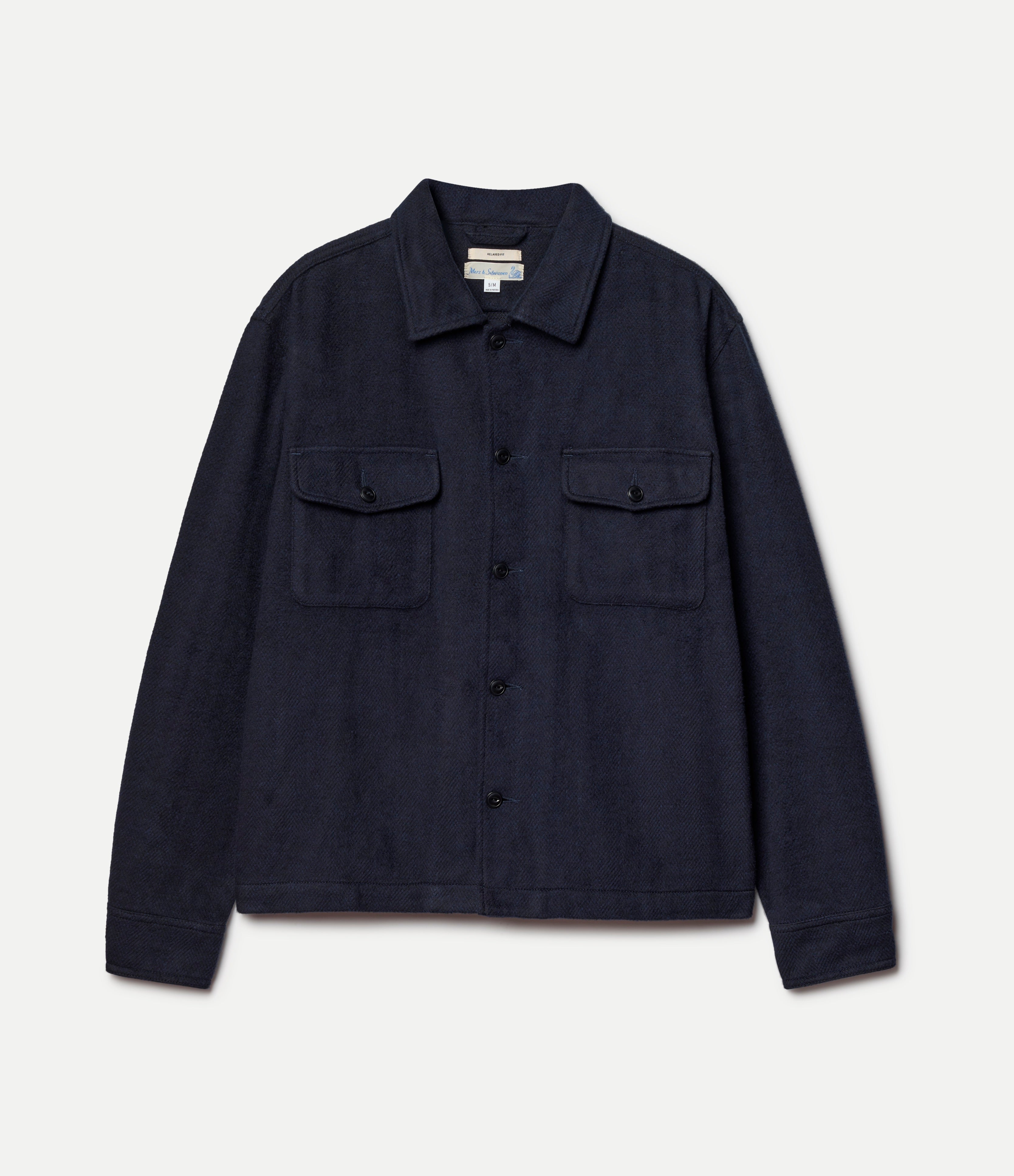 Navy blue shirt jacket on a light gray background