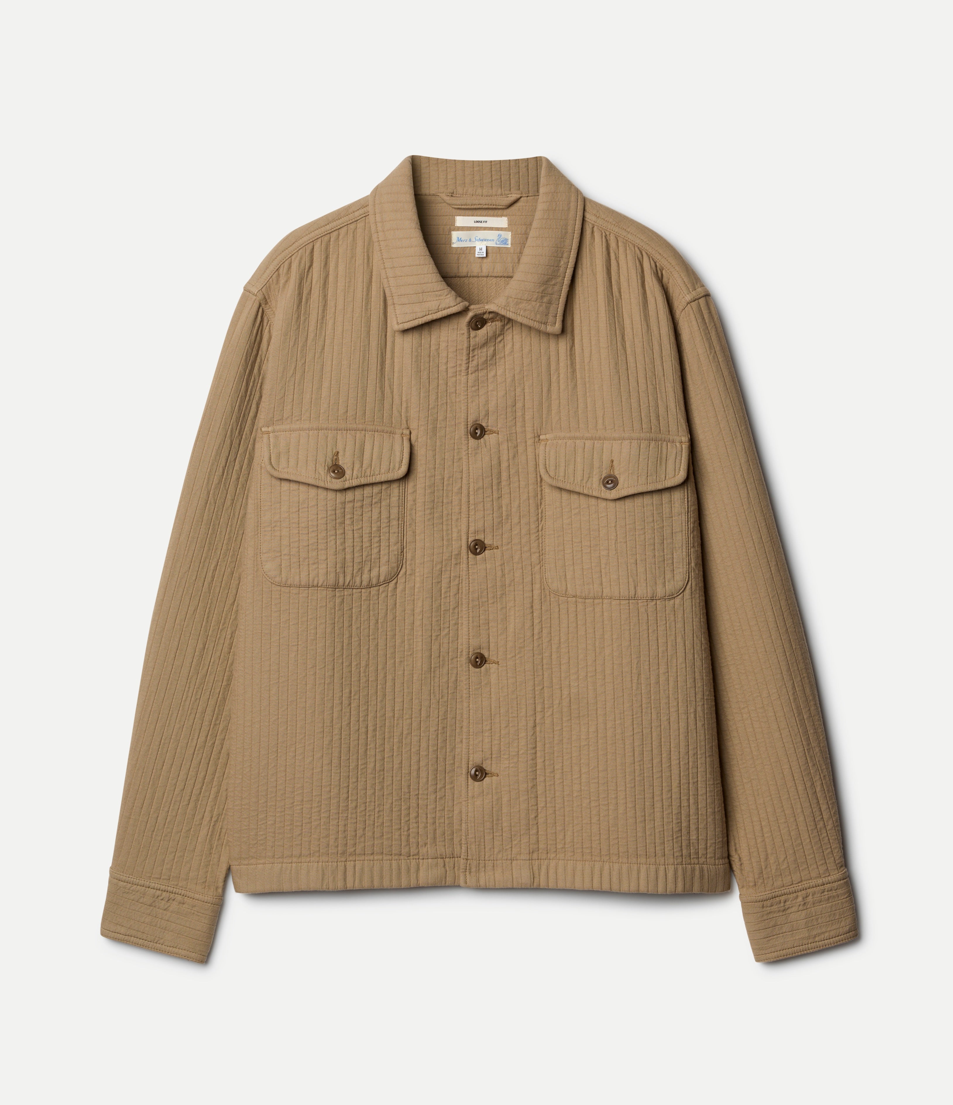 Beige padded shirt with button details on a light gray background