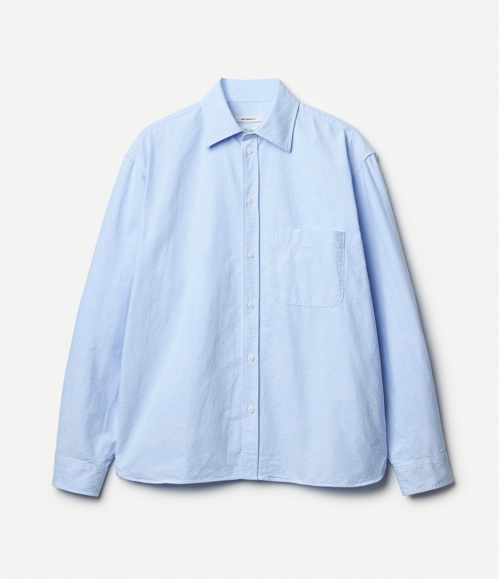 Light blue oxford shirt against a white background