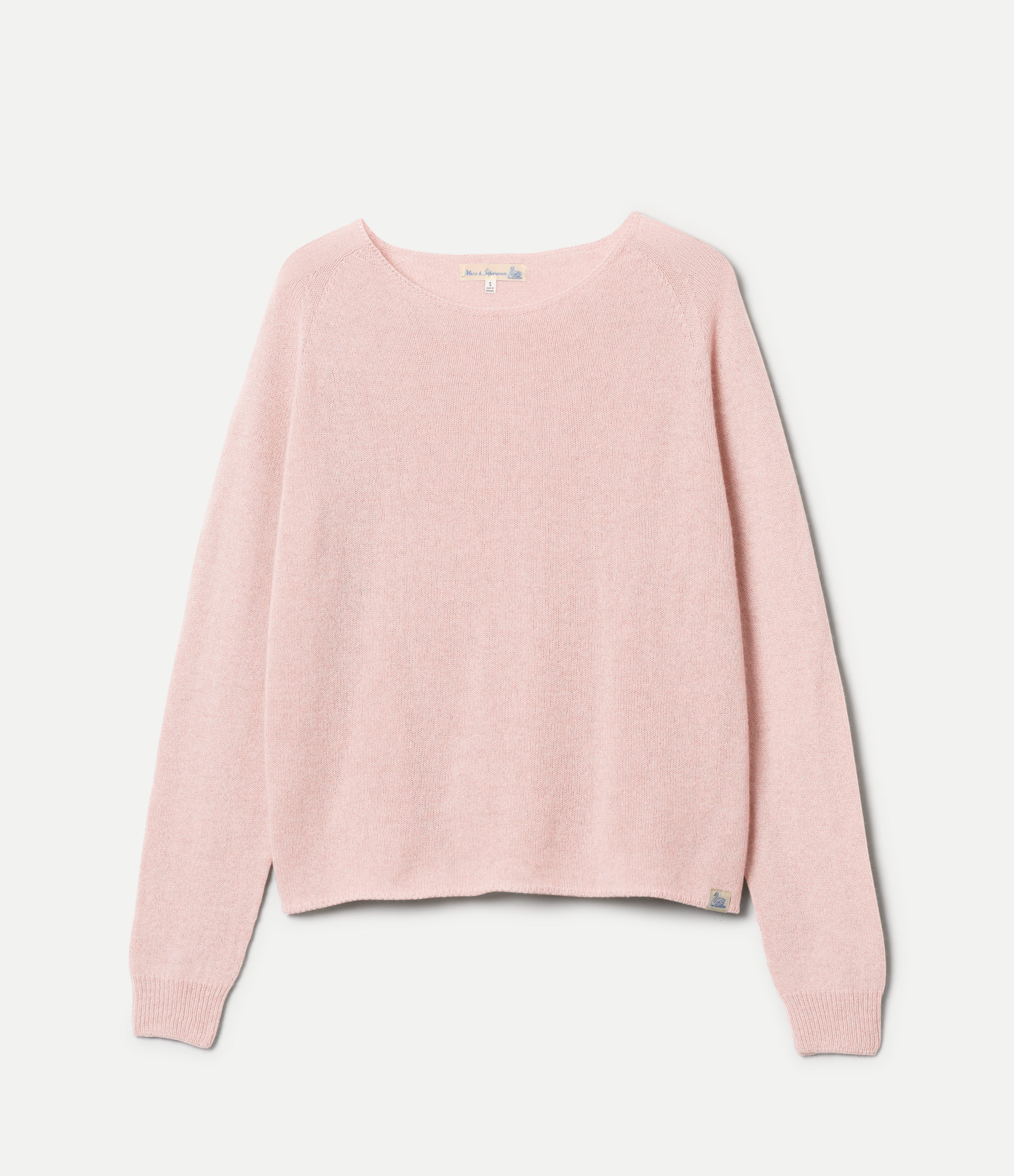 Pink sweater on a hanger against a white background