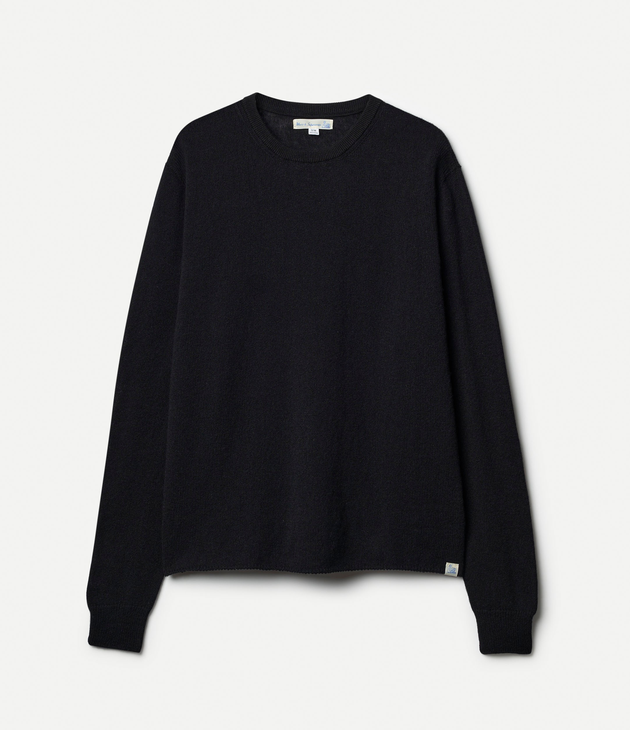 A black, long-sleeved, extra-fine merino wool-cashmere-silk sweater against a white background.