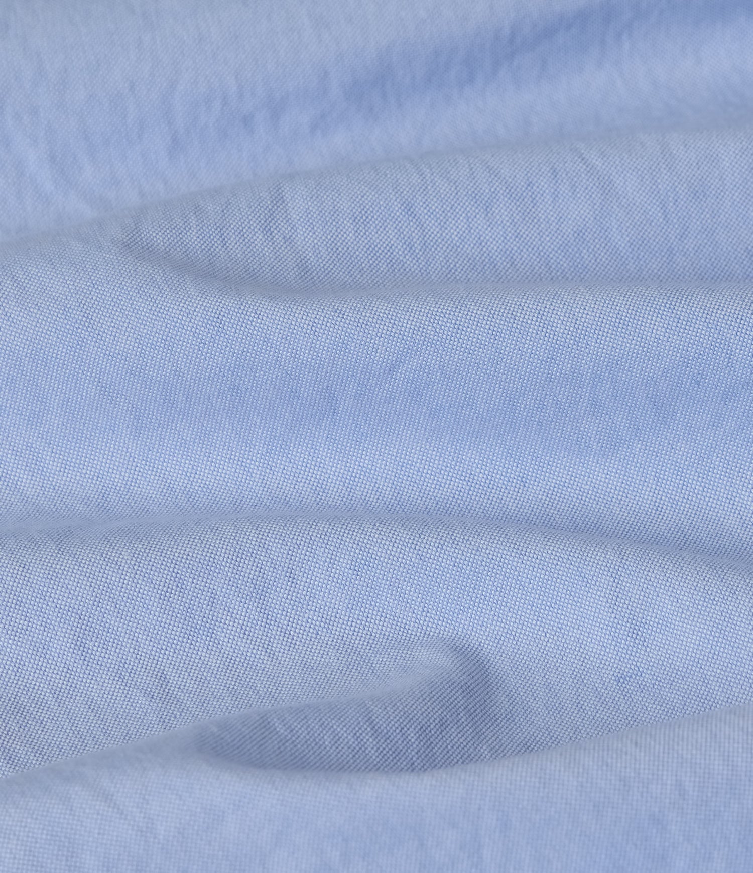 Close-up of light blue oxford fabric with subtle texture