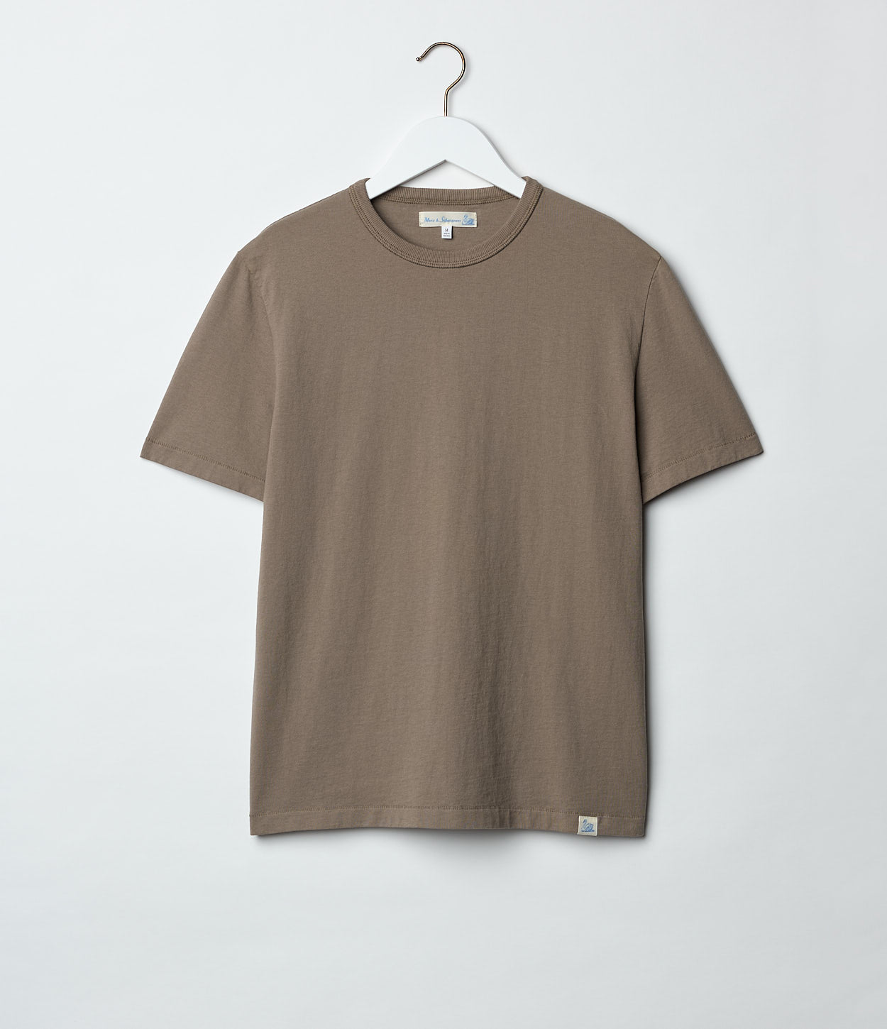 Grain t-shirt on a hanger against a white background