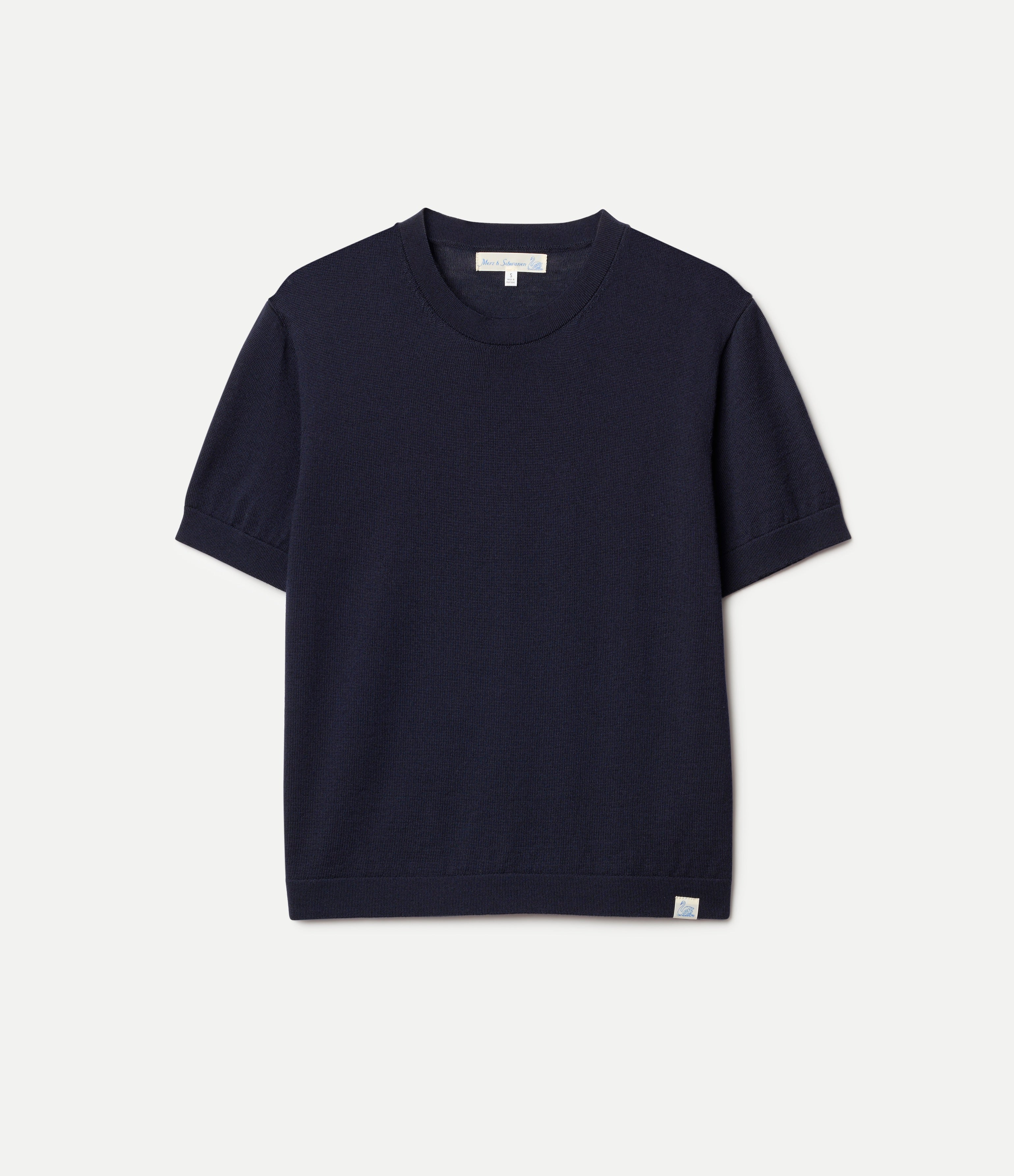 Navy blue knitted merino wool t-shirt on a light gray background