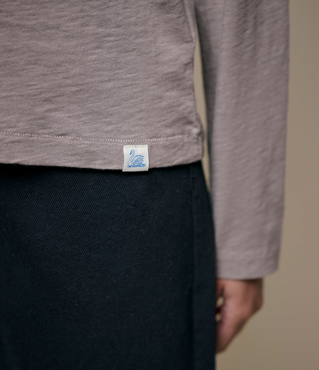 Gray long-sleeve shirt with a brand logo on a plain background