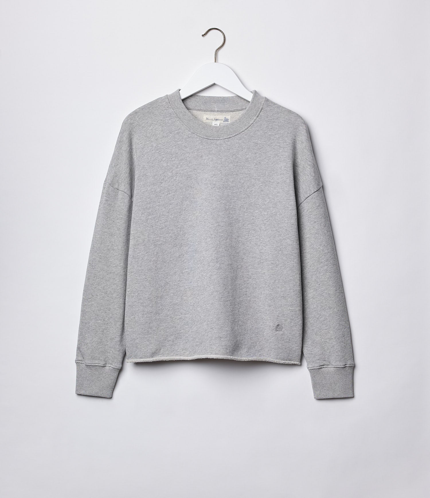 A gray fleece sweatshirt with a round neckline, long sleeves, and an open-edged hem, displayed on a hanger against a white background.