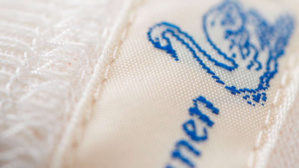 woven neck label with the blue swan logo