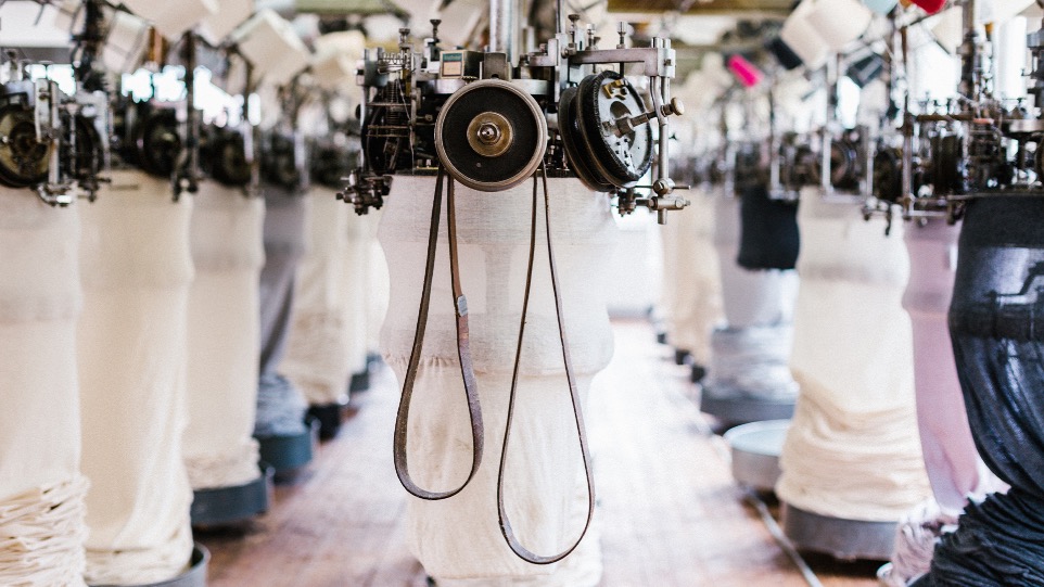 knitting room with multiple loop wheeler machines in a row