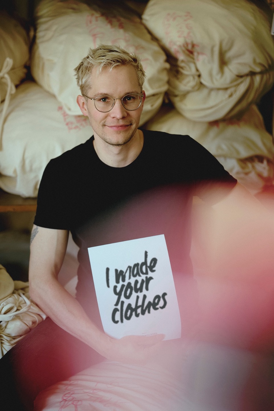 man holding fashion revolution week sign